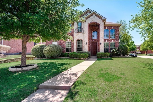 traditional home featuring brick siding and a front lawn