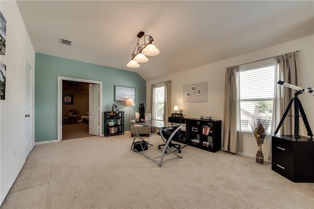 home office with visible vents, baseboards, and light carpet