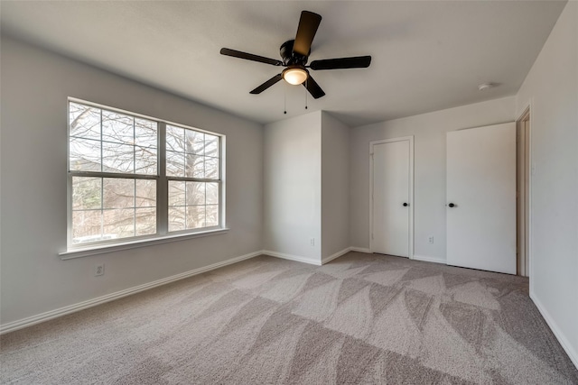 unfurnished bedroom with carpet flooring, baseboards, and multiple windows