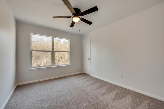 unfurnished room with baseboards, carpet, and a ceiling fan