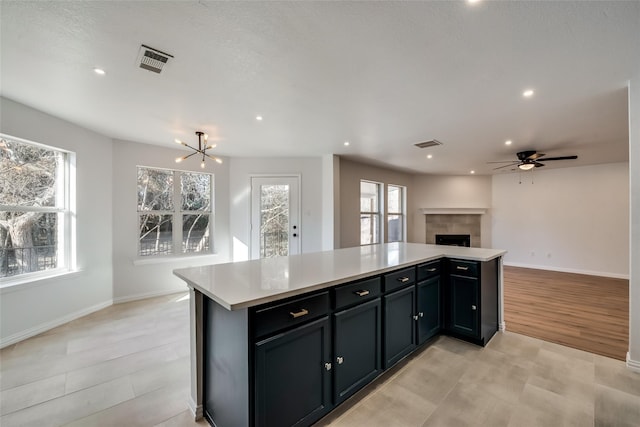 kitchen with visible vents, open floor plan, a healthy amount of sunlight, and light countertops