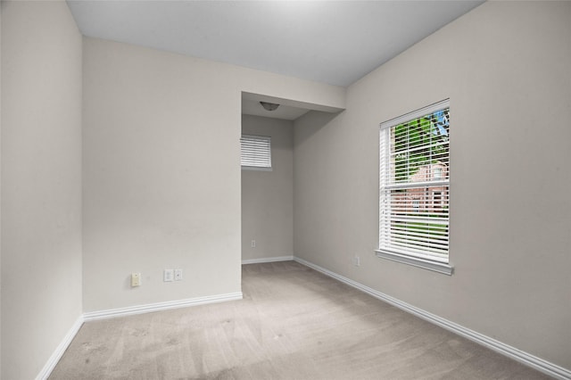 unfurnished room featuring carpet flooring and baseboards