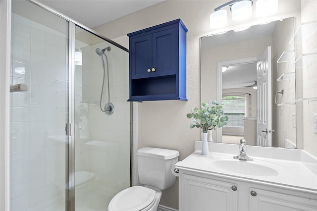 full bath featuring vanity, a stall shower, and toilet