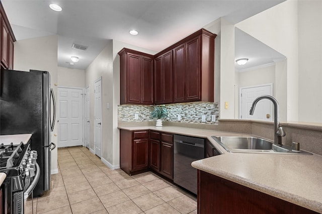 kitchen featuring visible vents, a sink, light tile patterned floors, light countertops, and stainless steel appliances