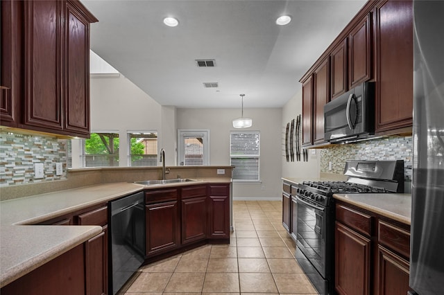 kitchen with a sink, appliances with stainless steel finishes, decorative backsplash, and visible vents