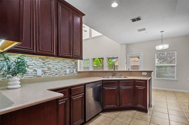 kitchen featuring visible vents, tasteful backsplash, stainless steel dishwasher, a sink, and reddish brown cabinets