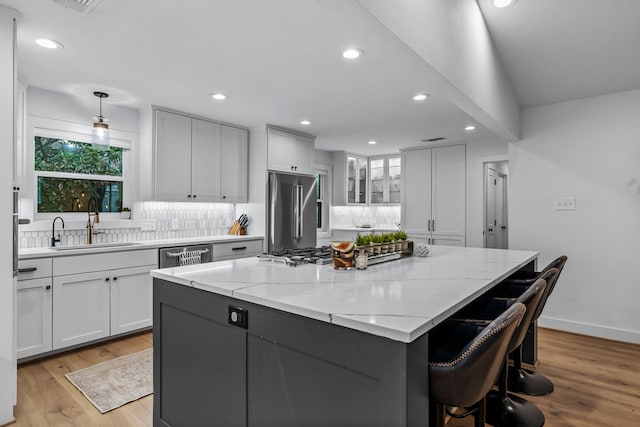 kitchen featuring recessed lighting, appliances with stainless steel finishes, a wealth of natural light, and a sink