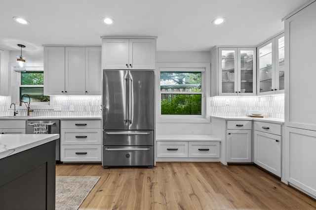 kitchen with light countertops, recessed lighting, appliances with stainless steel finishes, and a sink