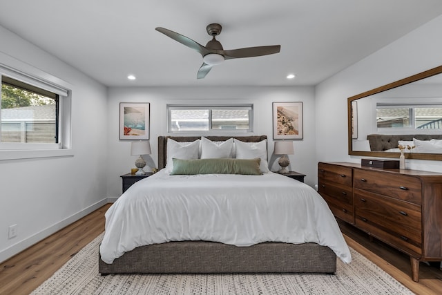 bedroom with recessed lighting, multiple windows, and wood finished floors