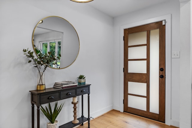 foyer entrance featuring baseboards and light wood-style flooring