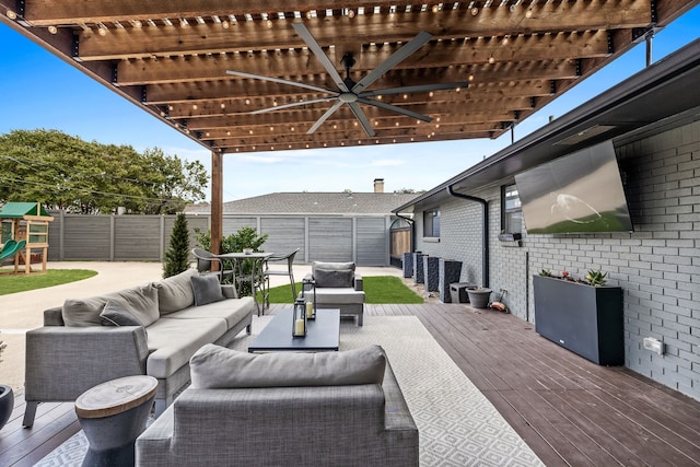 view of patio / terrace featuring ceiling fan, a deck, a fenced backyard, an outdoor living space, and a playground