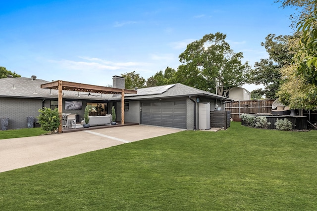 view of front of property with brick siding, an attached garage, roof mounted solar panels, and concrete driveway