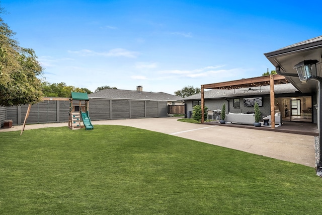 view of yard with a patio, fence, and a playground