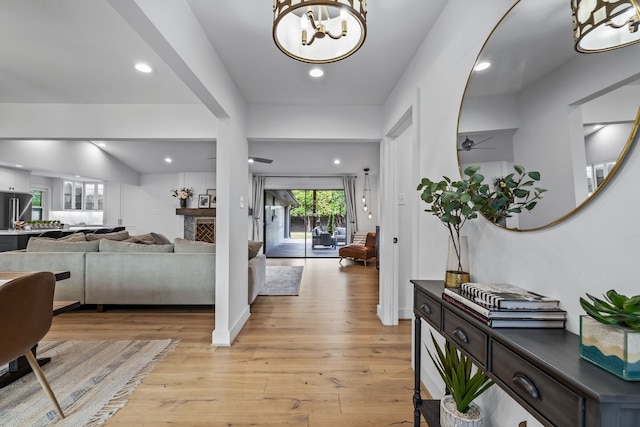 foyer featuring recessed lighting, ceiling fan with notable chandelier, and light wood-type flooring