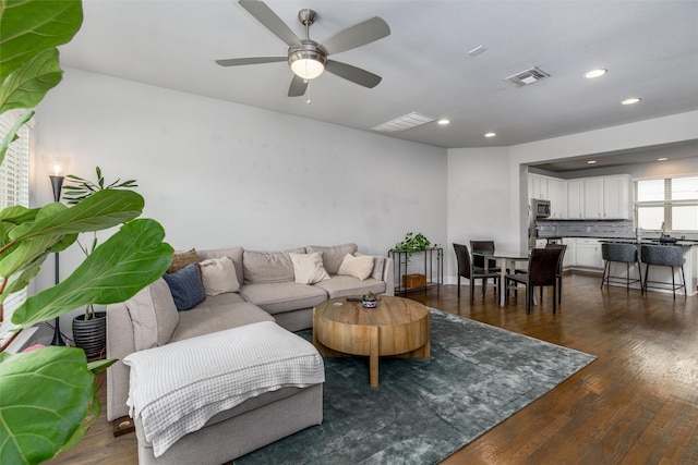 living area featuring recessed lighting, ceiling fan, visible vents, and dark wood finished floors