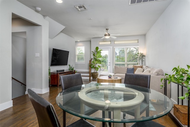 dining space with dark wood-style flooring, baseboards, visible vents, and ceiling fan