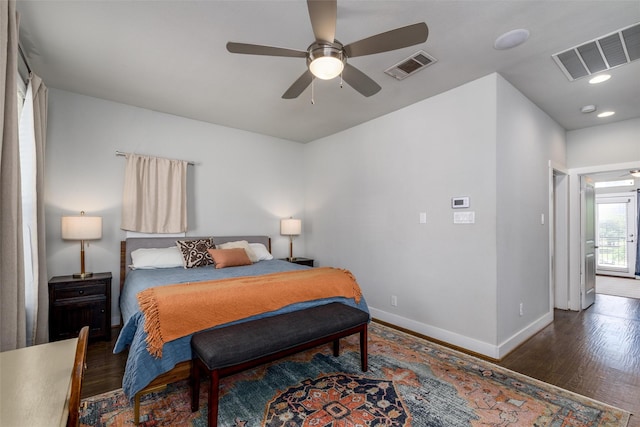 bedroom with visible vents, baseboards, ceiling fan, and wood finished floors