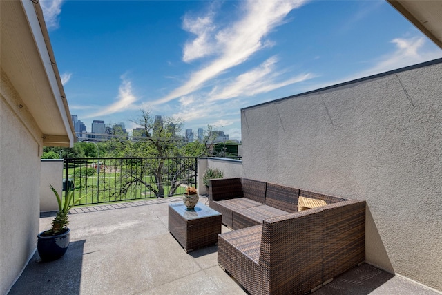balcony with an outdoor living space and a city view