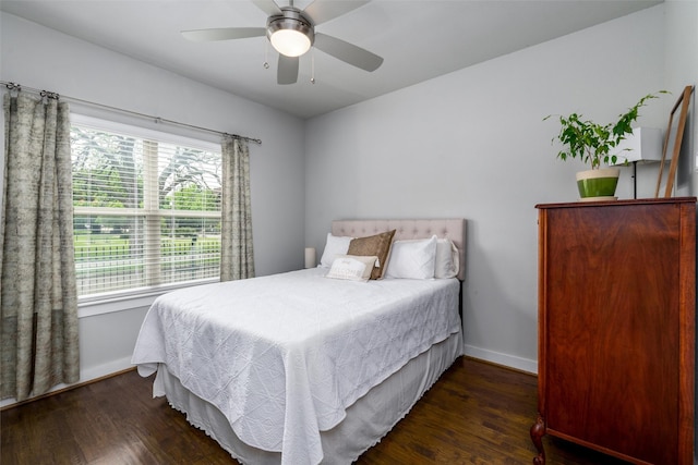 bedroom with baseboards, ceiling fan, and wood finished floors