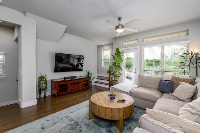living area featuring baseboards, a ceiling fan, and wood finished floors