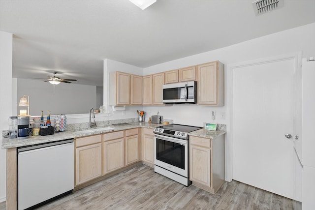 712 Riverflat Dr, Fort Worth, TX 76179 - kitchen featuring visible vents, light brown cabinets, a sink, light wood finished floors, and stainless steel appliances