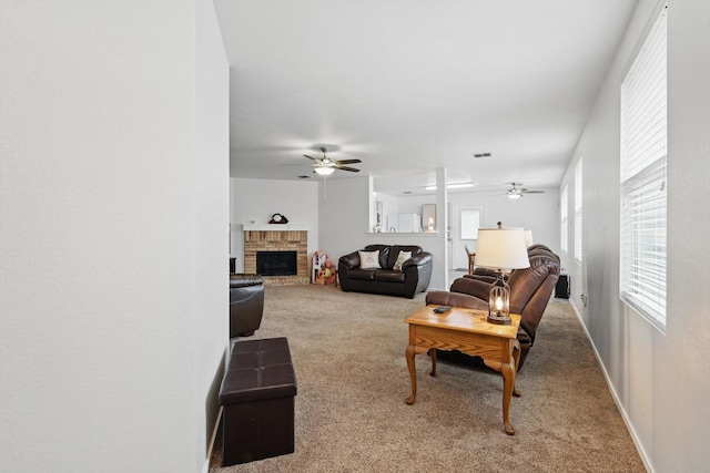 712 Riverflat Dr, Fort Worth, TX 76179 - carpeted living area featuring baseboards, a ceiling fan, a brick fireplace, and visible vents