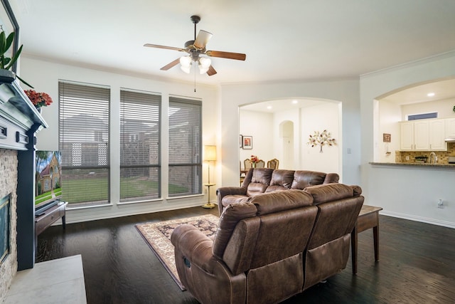 5624 Big River Dr, The Colony, TX 75056 - living room featuring ceiling fan, ornamental molding, wood finished floors, and arched walkways