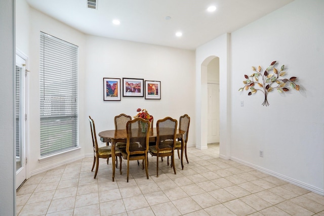 5624 Big River Dr, The Colony, TX 75056 - dining area featuring arched walkways, light tile patterned floors, visible vents, and recessed lighting
