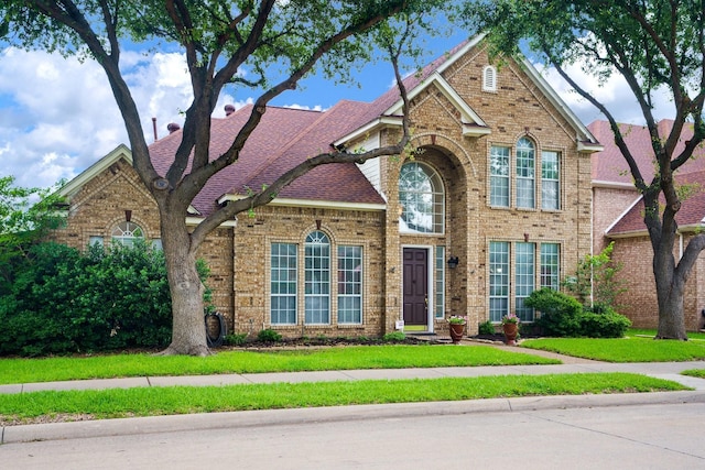 5624 Big River Dr, The Colony, TX 75056 - traditional-style home with a front lawn and brick siding