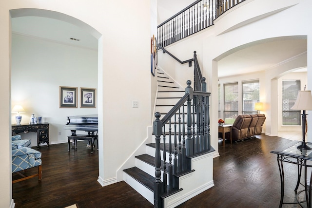 5624 Big River Dr, The Colony, TX 75056 - stairway featuring arched walkways, baseboards, visible vents, and wood finished floors
