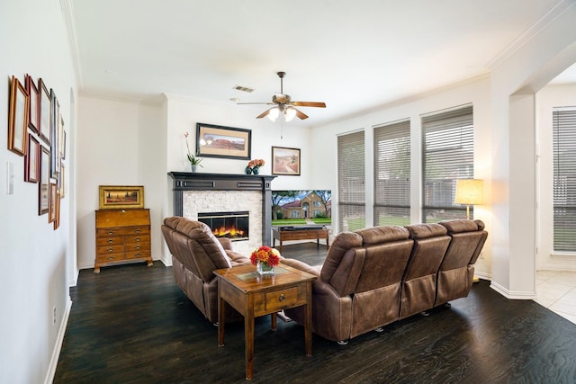 5624 Big River Dr, The Colony, TX 75056 - living room with wood finished floors, a fireplace, ceiling fan, crown molding, and baseboards
