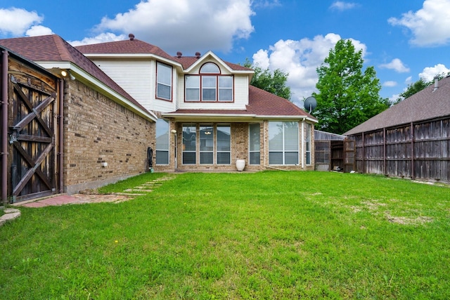 5624 Big River Dr, The Colony, TX 75056 - back of property with a yard, fence, a gate, and brick siding