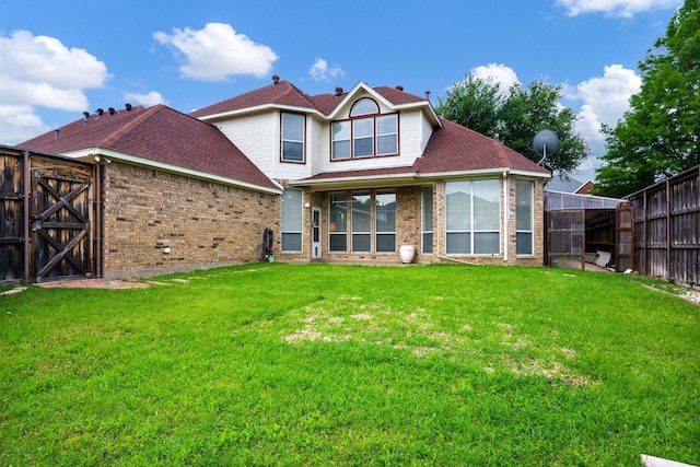 5624 Big River Dr, The Colony, TX 75056 - rear view of house featuring a fenced backyard, a gate, a yard, and brick siding