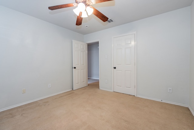 unfurnished bedroom featuring visible vents, baseboards, and light carpet