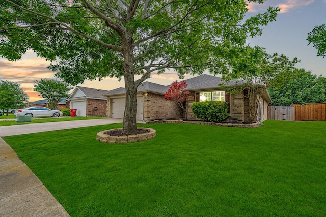 ranch-style home with concrete driveway, brick siding, a yard, and fence