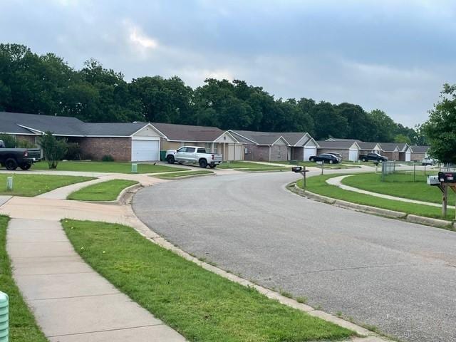 view of street featuring curbs, sidewalks, and a residential view