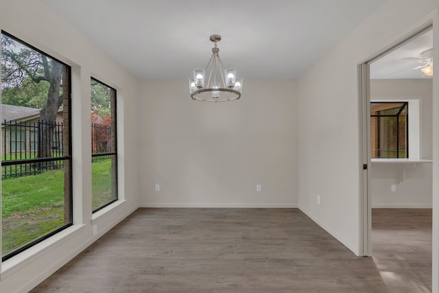 7804 Skylake Dr, Fort Worth, TX 76179 - spare room featuring baseboards, wood finished floors, and a notable chandelier