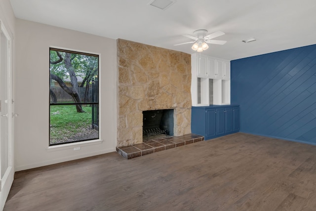 7804 Skylake Dr, Fort Worth, TX 76179 - unfurnished living room with a ceiling fan, baseboards, a stone fireplace, and wood finished floors