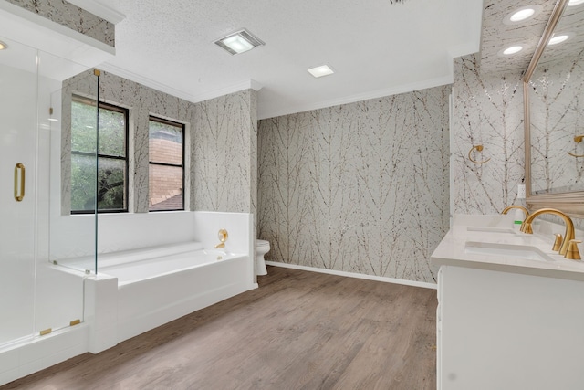 7804 Skylake Dr, Fort Worth, TX 76179 - bathroom with a garden tub, ornamental molding, double vanity, wood finished floors, and toilet