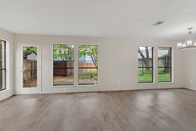 7804 Skylake Dr, Fort Worth, TX 76179 - spare room with baseboards, an inviting chandelier, wood finished floors, and visible vents