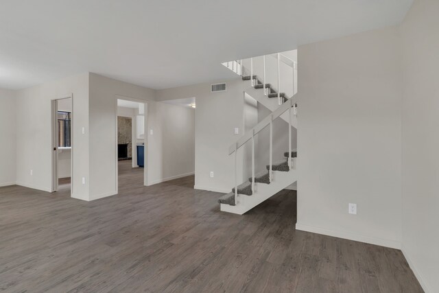 7804 Skylake Dr, Fort Worth, TX 76179 - unfurnished living room with stairs, dark wood-style flooring, baseboards, and visible vents