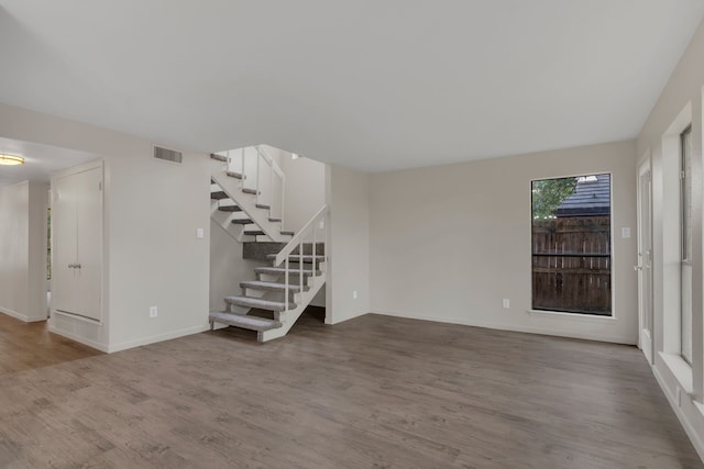 7804 Skylake Dr, Fort Worth, TX 76179 - unfurnished living room with stairs, baseboards, visible vents, and wood finished floors