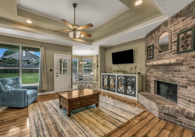 1821 Sandpiper Dr, Weatherford, TX 76088 - living room with crown molding, a raised ceiling, a ceiling fan, hardwood / wood-style flooring, and recessed lighting