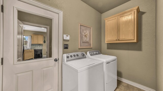 1821 Sandpiper Dr, Weatherford, TX 76088 - clothes washing area with washer and dryer, cabinet space, baseboards, and tile patterned flooring