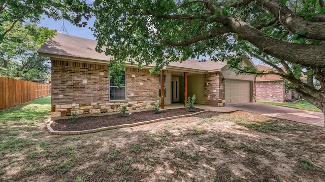 1821 Sandpiper Dr, Weatherford, TX 76088 - view of front of home featuring fence, an attached garage, brick siding, and driveway