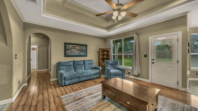 1821 Sandpiper Dr, Weatherford, TX 76088 - living room with hardwood / wood-style floors, arched walkways, a ceiling fan, crown molding, and a raised ceiling