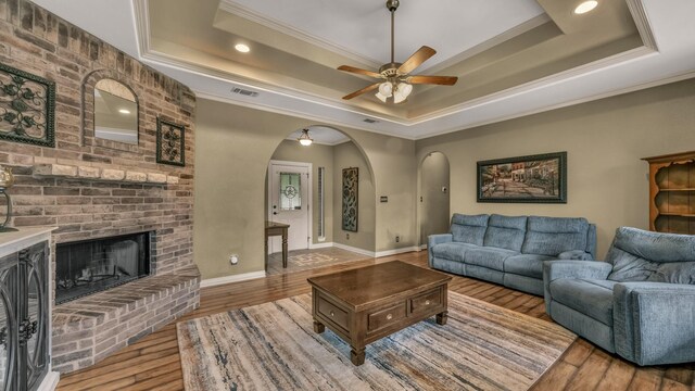 1821 Sandpiper Dr, Weatherford, TX 76088 - living area with a tray ceiling, arched walkways, crown molding, ceiling fan, and wood finished floors