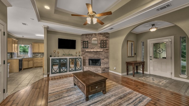 1821 Sandpiper Dr, Weatherford, TX 76088 - living area with a ceiling fan, light wood-type flooring, arched walkways, and ornamental molding