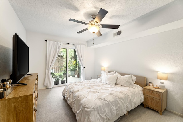 bedroom featuring visible vents, light carpet, access to exterior, ceiling fan, and a textured ceiling