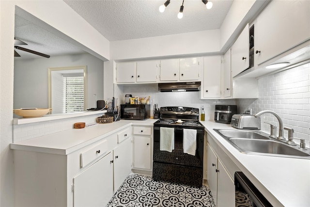 kitchen featuring a sink, black appliances, a textured ceiling, and under cabinet range hood